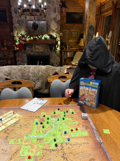 mysterious cloaked figure plays Carcassonne